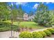 Picturesque community lawn framed by mature trees and elegant brick townhouses at 671 Brennan Dr, Decatur, GA 30033
