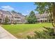 Beautifully maintained community lawn with lush greenery and traditional-style townhouses at 671 Brennan Dr, Decatur, GA 30033