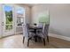 Cozy dining area with natural light and access to the outdoor balcony at 671 Brennan Dr, Decatur, GA 30033