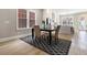 Cozy dining room with a stylish table and chairs, hardwood floors and access to kitchen at 671 Brennan Dr, Decatur, GA 30033