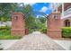 Charming brick entrance with archway and landscaped walkway leading into a community at 671 Brennan Dr, Decatur, GA 30033
