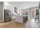 Modern kitchen boasting stainless steel appliances, an island with seating, and white cabinets at 671 Brennan Dr, Decatur, GA 30033