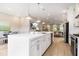 Open-concept kitchen with a large island, stainless steel appliances, and seamless flow to the living area at 671 Brennan Dr, Decatur, GA 30033