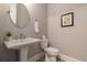 Elegant powder room with pedestal sink and modern fixtures at 671 Brennan Dr, Decatur, GA 30033