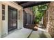 Condo entrance showing covered walkway, brick facade, and a black front door with white trim at 1101 Collier Nw Rd # P2, Atlanta, GA 30318