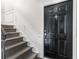Carpeted stairs leading to a black front door with decorative molding and unit number '2' at 1101 Collier Nw Rd # P2, Atlanta, GA 30318