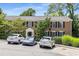 Brick condominium building featuring black shutters, manicured landscaping, and convenient parking at 1101 Collier Nw Rd # P2, Atlanta, GA 30318