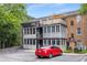 Exterior view showing red car, patio, porch and upper deck of the apartment complex at 1101 Collier Nw Rd # P2, Atlanta, GA 30318