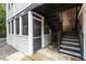 Rear exterior view of an apartment showing siding, staircase, and a screened in porch area at 1101 Collier Nw Rd # P2, Atlanta, GA 30318