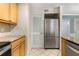Updated kitchen features stainless steel fridge, granite counters, and tile flooring at 1101 Collier Nw Rd # P2, Atlanta, GA 30318