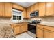 The updated kitchen has stainless steel appliances, granite counters and modern cabinets at 1101 Collier Nw Rd # P2, Atlanta, GA 30318