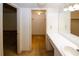 This bathroom features a vanity with sink and a view into the walk-in closet at 1150 Collier Rd # K3, Atlanta, GA 30318