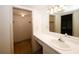 This bathroom features a vanity with sink and a view into the walk-in closet at 1150 Collier Rd # K3, Atlanta, GA 30318