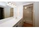This bathroom includes a vanity with sink and a view into the tiled tub/shower area at 1150 Collier Rd # K3, Atlanta, GA 30318