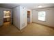 A cozy bedroom boasts neutral carpet, natural light, and access to the kitchen and bathroom at 1150 Collier Rd # K3, Atlanta, GA 30318