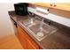 This kitchen features a stainless steel sink, modern countertop, and wood cabinets at 1150 Collier Rd # K3, Atlanta, GA 30318