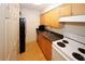 Bright kitchen with stainless steel sink, wood cabinets and range at 1150 Collier Rd # K3, Atlanta, GA 30318
