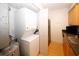 Compact laundry room featuring a stacked washer/dryer beside the sink and refrigerator at 1150 Collier Rd # K3, Atlanta, GA 30318