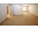 Open-concept living room with carpet flooring and an entrance to the attached bathroom at 1150 Collier Rd # K3, Atlanta, GA 30318
