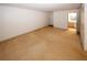 Spacious living room with plush carpeting and white walls, leads to the bathroom at 1150 Collier Rd # K3, Atlanta, GA 30318