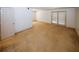 Spacious living room with sliding glass door, carpet floors, and white walls at 1150 Collier Rd # K3, Atlanta, GA 30318