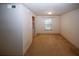Cozy living room with plush carpet, white walls, and open access to a kitchen at 1150 Collier Rd # K3, Atlanta, GA 30318