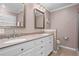 Bathroom featuring dual sinks with granite countertops, white cabinets, and neutral colored walls at 261 Lamplighter Se Ln, Marietta, GA 30067