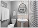 Bathroom featuring a pedestal sink, white tile backsplash, and decorative mirror at 261 Lamplighter Se Ln, Marietta, GA 30067