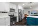 Modern kitchen with stainless steel appliances, white cabinets, hardwood floors, and a stylish blue island at 261 Lamplighter Se Ln, Marietta, GA 30067