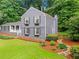 Well-maintained home exterior featuring a manicured lawn, gray siding, and tasteful landscaping at 261 Lamplighter Se Ln, Marietta, GA 30067