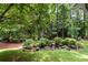 Landscaped backyard with mature trees and greenery at 3754 Wyntuck Nw Cir, Kennesaw, GA 30152