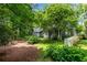 Exterior with wooded backyard and lush landscaping at 3754 Wyntuck Nw Cir, Kennesaw, GA 30152