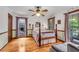 Comfortable bedroom with hardwood floors, ceiling fan and natural light from the windows at 3754 Wyntuck Nw Cir, Kennesaw, GA 30152