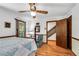 Bedroom featuring hardwood floors, ceiling fan, and access to a closet and staircase at 3754 Wyntuck Nw Cir, Kennesaw, GA 30152