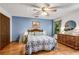 Bedroom with blue accent wall, hardwood floors and natural light from the windows at 3754 Wyntuck Nw Cir, Kennesaw, GA 30152