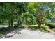 Spacious driveway with mature trees, leading to a charming home at 3754 Wyntuck Nw Cir, Kennesaw, GA 30152