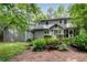 Two-story gray house with mature landscaping featuring a screened porch at 3754 Wyntuck Nw Cir, Kennesaw, GA 30152