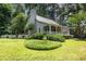 Landscaped yard featuring a gray home with a chimney and a quaint, white picket fence at 3754 Wyntuck Nw Cir, Kennesaw, GA 30152