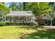 Charming home featuring a inviting front porch, manicured lawn, and convenient carport at 3754 Wyntuck Nw Cir, Kennesaw, GA 30152