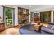 Warm living room featuring stone fireplace, hardwood floors, and outdoor views at 3754 Wyntuck Nw Cir, Kennesaw, GA 30152