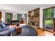 Inviting living room with stone fireplace, hardwood floors, and large windows offering natural light at 3754 Wyntuck Nw Cir, Kennesaw, GA 30152