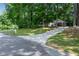 A street view of a home with a driveway and lush green yard at 3754 Wyntuck Nw Cir, Kennesaw, GA 30152