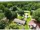 An aerial view of a home with a large, well-maintained yard surrounded by lush greenery and mature trees at 3844 Sw Saddle Ridge Dr, Snellville, GA 30039