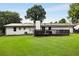 Spacious backyard featuring a well-maintained lawn and a dark deck, perfect for outdoor entertaining and relaxation at 3844 Sw Saddle Ridge Dr, Snellville, GA 30039