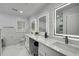 Bright bathroom with a double vanity, marble countertops, and illuminated mirrors at 3844 Sw Saddle Ridge Dr, Snellville, GA 30039