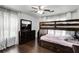 Bedroom with bunk beds, wood floors, ceiling fan, and dresser with large mirror at 3844 Sw Saddle Ridge Dr, Snellville, GA 30039