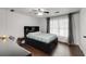 Bedroom with desk and comfortable platform bed, featuring wood floors and a ceiling fan at 3844 Sw Saddle Ridge Dr, Snellville, GA 30039