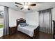 A cozy bedroom features wood floors, ceiling fan, and a comfortable bed at 3844 Sw Saddle Ridge Dr, Snellville, GA 30039