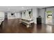 Spacious dining room with hardwood floors, built-in storage, and a farmhouse-style dining table at 3844 Sw Saddle Ridge Dr, Snellville, GA 30039