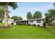Well-maintained house featuring a lush green lawn, mature trees, and attractive landscaping for enhanced curb appeal at 3844 Sw Saddle Ridge Dr, Snellville, GA 30039